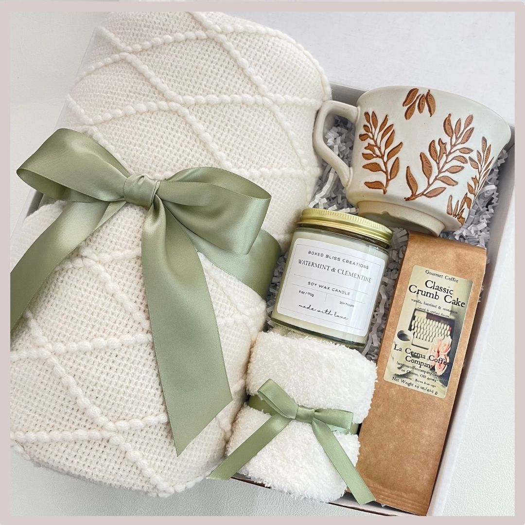 sage green gift basket with blanket, mug with flowers, gourmet coffee, soy candle, socks