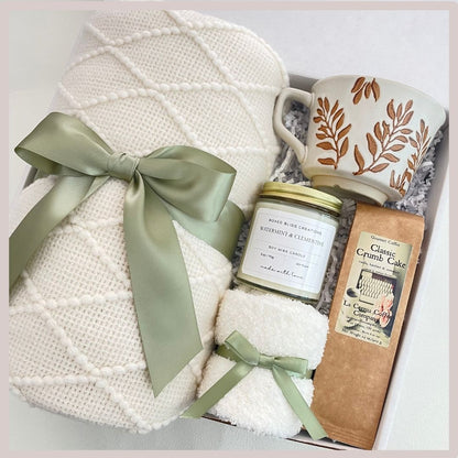 sage green gift basket with blanket, mug with flowers, gourmet coffee, soy candle, socks