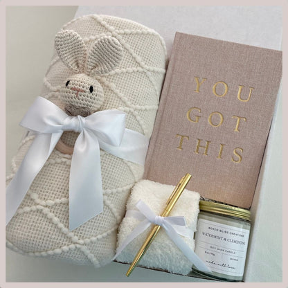 new mom and baby gift set with journal, pen, baby gift rattle, soy wax candle, sock